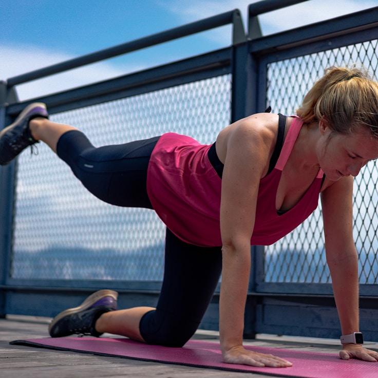 Women in a fitness class doing stretching and mobility exercises